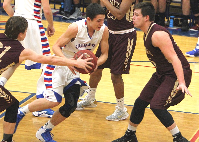 California's Wyatt Percival drives through a pair of Eldon players in the Pintos' 70-59 win.