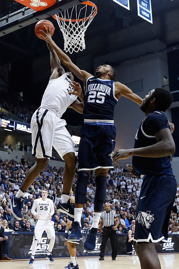 Villanova's Mikal Bridges (25) blocks a shot by Xavier's Quentin Goodin in the second half of Saturday's game in Cincinnati.