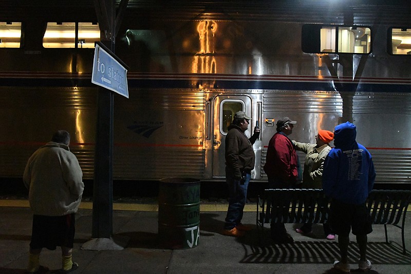 Travelers wait Monday in downtown Texarkana to board an Amtrak train arriving from Dallas.