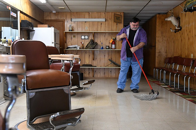 Barber Tony Davis cleans up shop before today's grand opening of Tony's Custom Haircuts & Hot Shaves. The shop is at the long-time location of Karl's Barber Shop at 914 E. Third Street near downtown Texarkana. Davis owns a barbershop in Jonesboro, Ark., and is looking to bring his trade back home to Texarkana. "I'm from the Little River County and the Texarkana area, these are my people so I'm excited to be home,"  Davis said. 