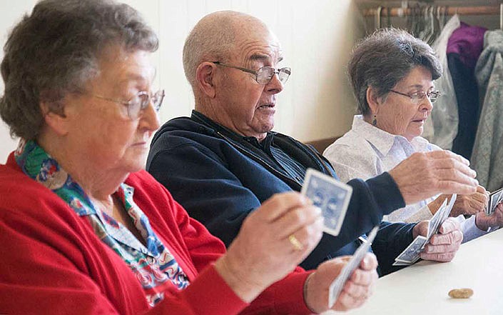 Betty Rountree, Homer Spradlin and Pat Butler of Auxvasse sort their cards during a round of the game "Ten Point Pitch" during Loafer's Week 2014. 