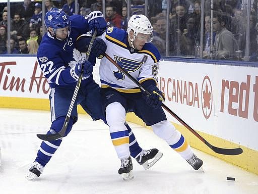 St. Louis Blues center Paul Stastny (26) battles with Toronto Maple Leafs defenseman Nikita Zaitsev (22) for the puck behind the net during the first period of an NHL hockey game Thursday, Feb. 9, 2017, in Toronto. (Nathan Denette/The Canadian Press via AP)