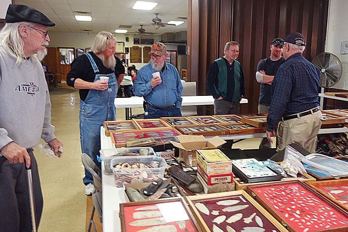 Attendees of the Early Man Artifacts and Antique Gun Show browse the collection of Terry Allen. 
