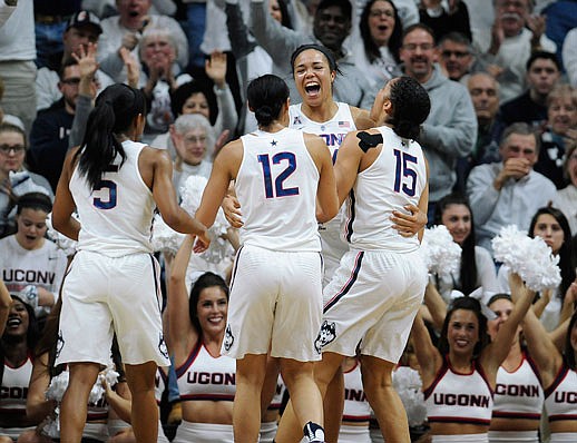 Napheesa Collier (center) reacts with Connecticut teammates (from left) Crystal Dangerfield, Saniya Chong and Gabby Williams in the second half of Monday night's 66-55 win against South Carolina in Storrs, Conn. Collier, who played her freshman season at Jefferson City High School, finished with 18 points and nine rebounds in the victory.
