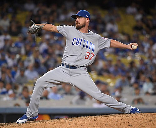 This Oct. 19, 2016, file photo, shows Cubs relief pitcher Travis Wood throwing during the seventh inning of Game 4 of the National League Championship Series against the Dodgers in Los Angeles.