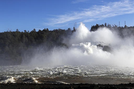 Water gushes from the Oroville Dam's main spillway Tuesday, Feb. 14, 2017, in Oroville, Calif. Crews working around the clock atop the crippled Oroville Dam have made progress repairing the damaged spillway, state officials said Tuesday. 