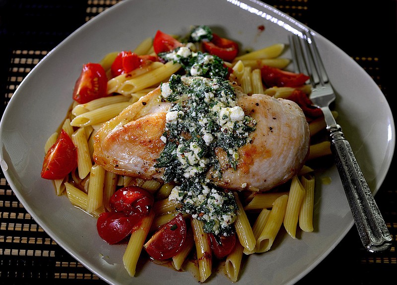 Golden brown chicken breasts top pasta with a goat cheese vinaigrette.