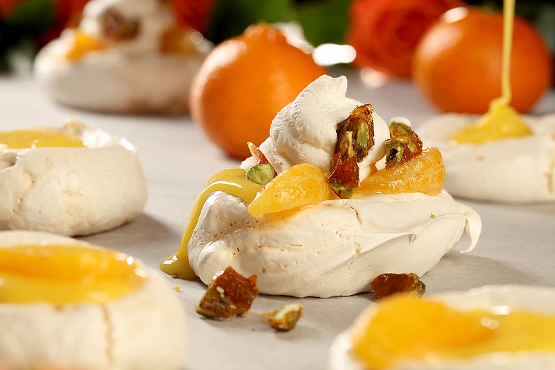 Meringues loaded with clementine curd and whipped cream and topped with candied pistachios. 