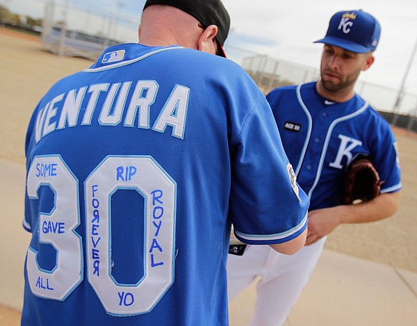 Royals pitcher Danny Duffy talks to a fan wearing a jersey in memory of Yordano Ventura, a Royals pitcher who was killed in a car crash last month, during spring training Tuesday in Surprise, Ariz.
