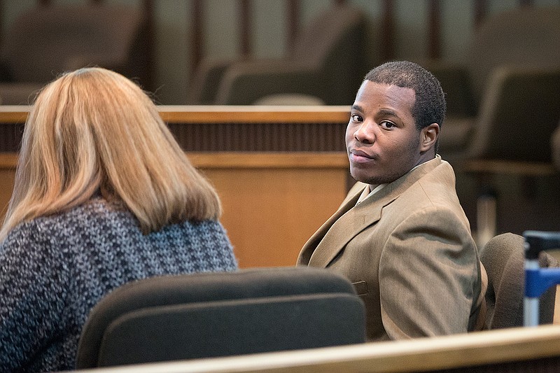 Marquell Smith looks over his shoulder at the gallery during a recess in the second day of testimony Wednesday. Smith was on trial for the 2015 murder of Christopher Guibeau during a robbery and was found guilty Wednesday evening.