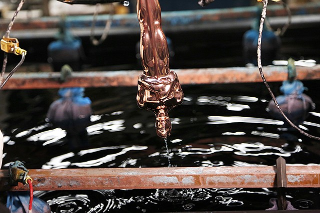 A copper-plated Oscar statuette is run through a series of chemical baths Tuesday at Epner Technology in the Brooklyn borough of New York. Each statuette is coated in three layers — the final one the iconic gold — and every Oscar fist-pumped or tearfully cradled by Academy Award winners is first cast, buffed and fussed over by people far from Hollywood who have spent the last several months making 60 identical gold Oscars for the Feb. 26 awards.