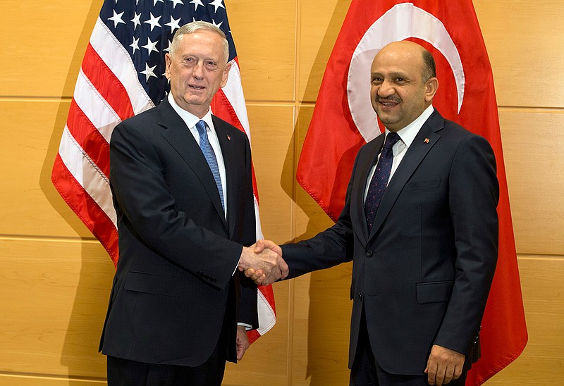 U.S. Secretary of Defense Jim Mattis, left, speaks with Turkish Defense Minister Fikri Isik during a meeting at NATO headquarters in Brussels on Wednesday, Feb. 15, 2017. For U.S. Defense Secretary Jim Mattis, the next few days will be a reassurance tour with a twist. He is expected to tell allies the U.S. is committed to NATO and is also hoping to secure bigger defense spending commitments. 