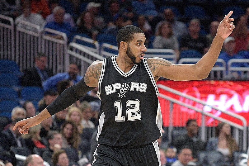 San Antonio Spurs forward LaMarcus Aldridge (12) celebrates after scoring during the first half of the team's NBA basketball game against the Orlando Magic in Orlando, Fla., Wednesday, Feb. 15, 2017. 