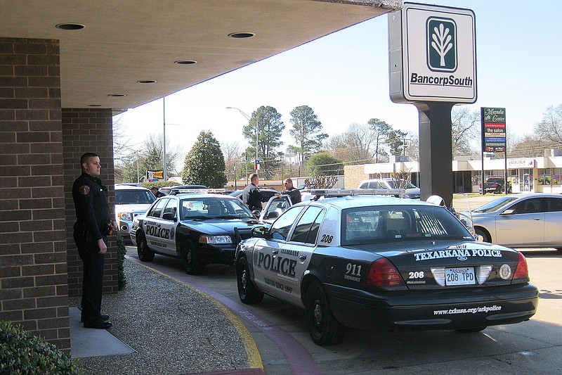 Texarkana, Ark., police investigate the scene of a morning robbery of the BancorpSouth branch in the 2200 block of North State Line Avenue. A man wearing a hooded sweatshirt and a mask displayed a gun and demanded money from the teller. This is the second time this year that this location has been robbed.