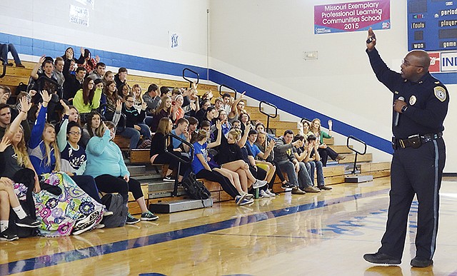 Gary Hill, chief of the Lincoln University Police Department, addresses students at Russellville High School Thursday during a morning assembly.