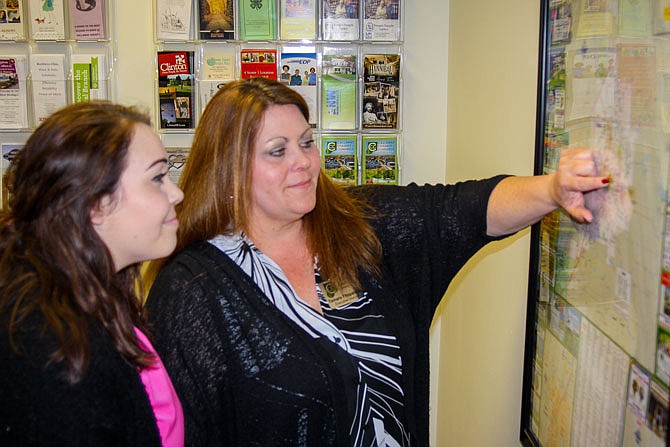 Executive Director Tamara Fitzpatrick, right, shows Brittney Glidewell a map of Fulton. Fitzpatrick recently oversaw the launch of the Callaway Chamber of Commerce's new website, callawaychamber.net.