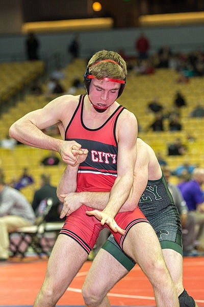 Reece Neighbors of Jefferson City tries to get out of the grasp of Charley Genisio of Staley in first round action at the state wrestling championships at Mizzou Arena in Columbia.
