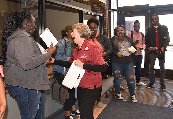 Joycelyn Dowdy is all smiles after handing Ajane Crockett, left, a card and cookies as Dowdy and several residents of Primrose Retirement Community participated in Random Acts of Kindness Day on Friday. The residents went to Scruggs Center at Lincoln University and handed out handwritten cards and treats to students.