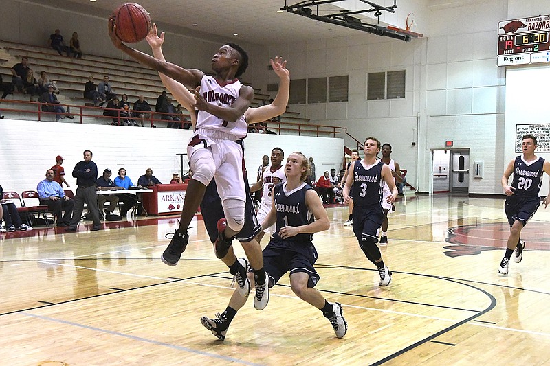 Arkansas High's Taviron Oliver goes for a layup after a breakaway Saturday against Greenwood at Razorback Gym in Texarkana, Ark. Oliver finished with 16 points for the Razorbacks.