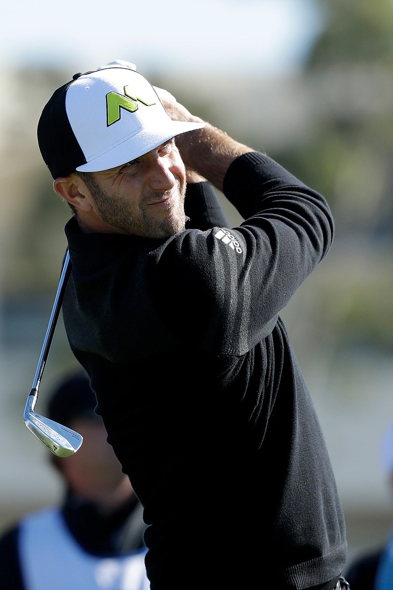 Dustin Johnson watches his tee shot on the 16th hole of the south course during the Pro-Am event at the Farmers Insurance Open golf tournament Wednesday, Jan. 25, 2017, in San Diego. 