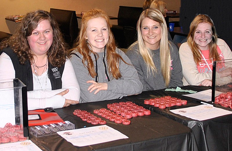 Hannah Mansell, Hope Wallace, Mallory York and Emily Gast, members of the Rotaract Club of William Woods University, work the betting table at the 2016 event.