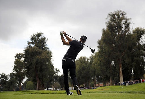 Dustin Johnson tees off on the 13th hole during the second round of the Genesis Open golf tournament at Riviera Country Club, Saturday, Feb. 18, 2017, in the Pacific Palisades area of Los Angeles.