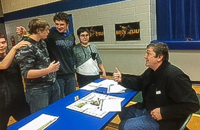 "The Life of JFK" board game creators Devin Colbert-Grimes, left, Jordon Renner, Kyle Wetherell and Dylan Formantes get a thumbs-up on their creative efforts from parent Craig Somerville, right, during South Callaway Middle School History Con 17.