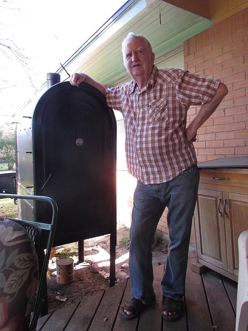 In a Feb. 1, 2017 photo, Glen McDonald, former Friendswood, Texas postmaster, now spends most of his days on his back porch. One of his prized possessions is an old mail box converted into a smoker.