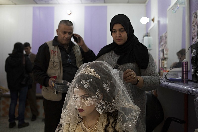 Shahad Ahmed Abed, 16, gets her hair done in a hair salon in Khazer for the wedding on Thursday, Feb. 16, 2017. Abed and her husband Hussein Zeino Danoon both fled from Mosul within the last month, just as Iraqi forces pushed Islamic State militants out of the eastern side of the city. 
