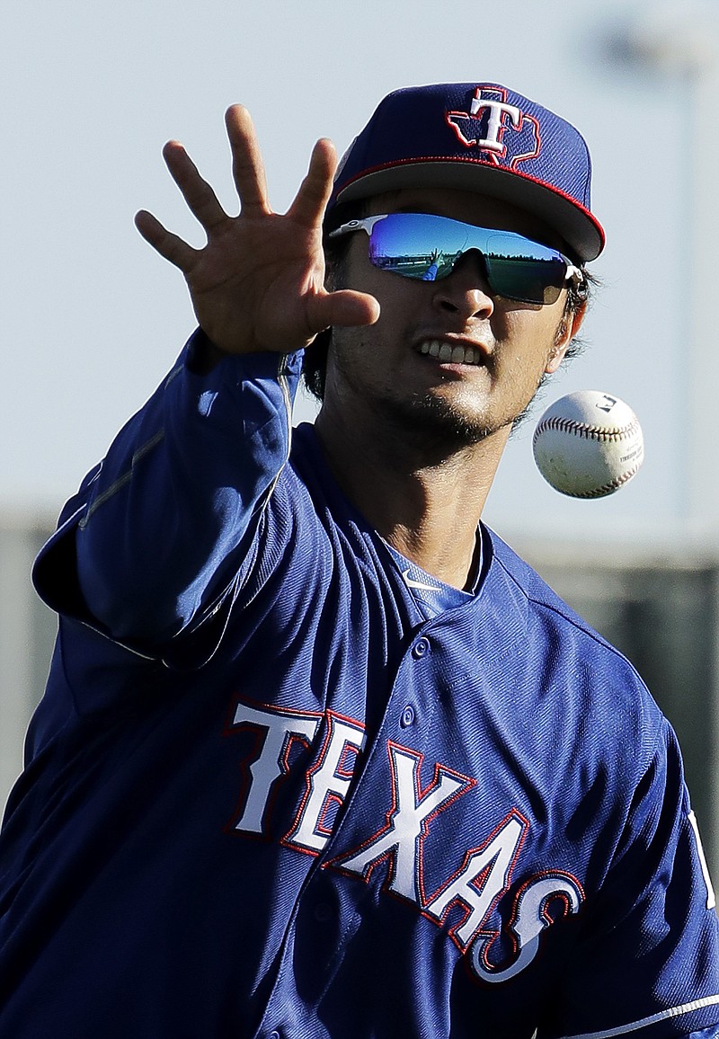 Texas Rangers pitcher Yu Darvish participates in a drill during spring training baseball practice Thursday, Feb. 16, 2017, in Surprise, Ariz.