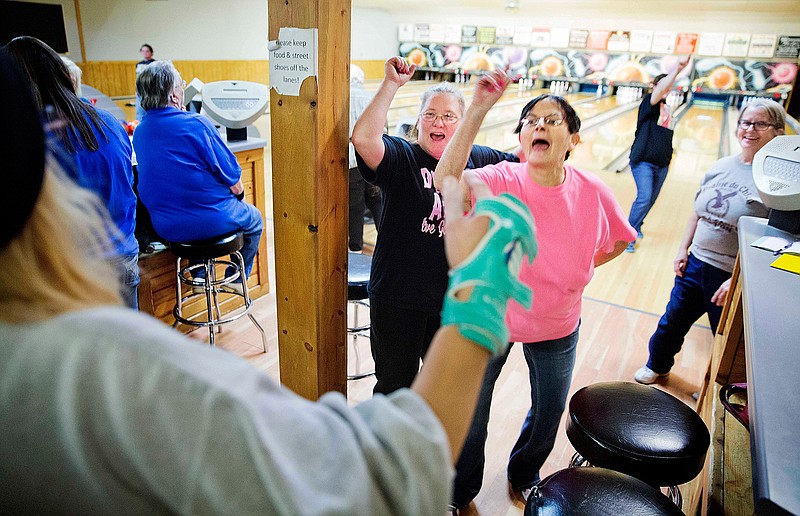 Jackie Suelflow, right, and Mikey Clanton, left, dance and sing during a ladies bowling night in Prairie du Chien, Wis., Wednesday, Jan. 18, 2017. Here in Crawford County, residents often recite two facts about their hometown, the first one proudly: It is the second-oldest community in the state. The next is that it's also one of the poorest. There are no rusted-out manufacturing plants to embody this discontent. The downtown main street bustles with tourists come summer. Just a few vacant storefronts hint at the seething resentment that life still seems harder here than it should. 