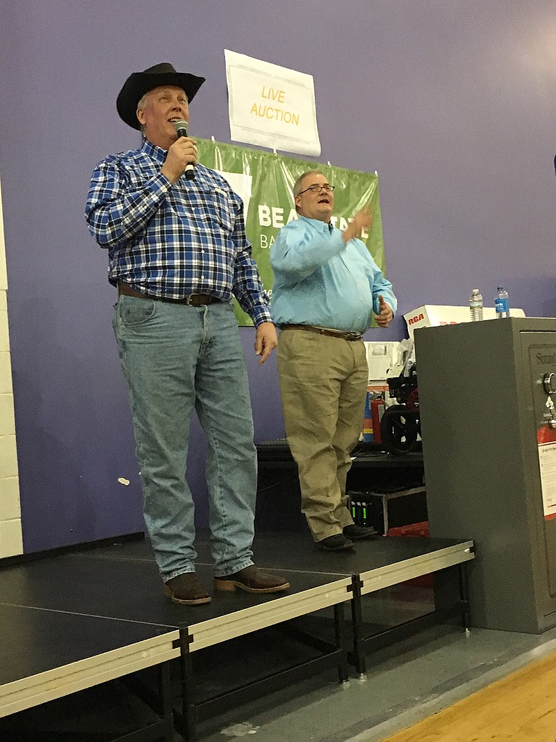 Domtar General Manager Bob Grygotis, left, was a guest auctioneer helping John Nutt, owner of Nutt Auction Co., raise money Feb. 4 for the sixth annual Ashdown Community Auction. The event raised $60,000, bringing the event's six-year total to $235,000. The money goes toward a variety of projects for the city.