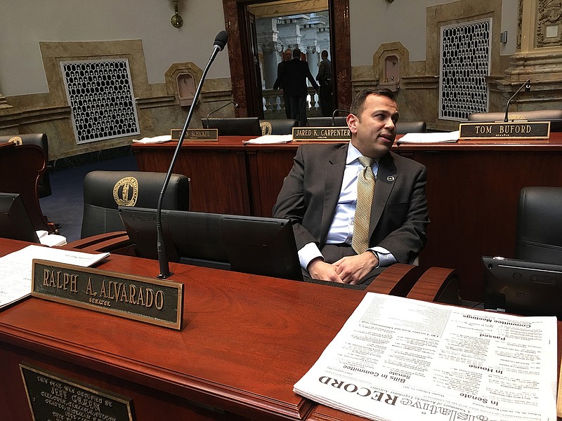 In a Monday, Feb. 13, 2017 photo, Kentucky Republican state Sen. Ralph Alvarado sits in the Senate floor in Frankfort, Ky. Alvarado, a medical doctor in the Kentucky Senate, is leading the effort to restrict smoking in a state that leads the country in smoking rates.