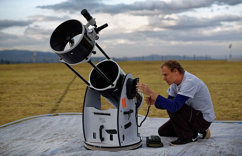 In this photo taken Friday, Feb. 3, 2017, astronomer and company co-founder Daniel Chu Owen sets up a telescope during a visit by The Traveling Telescope to show students the science of astronomy, at St Andrew's School near Molo in Kenya's Rift Valley. Although Kenya lies on the equator and has dramatic nighttime skies in rural areas, children find it hard to name planets and other bodies as astronomy is rarely taught in schools - but that is changing as The Traveling Telescope visits some of the country's most remote areas with telescopes and virtual reality goggles.