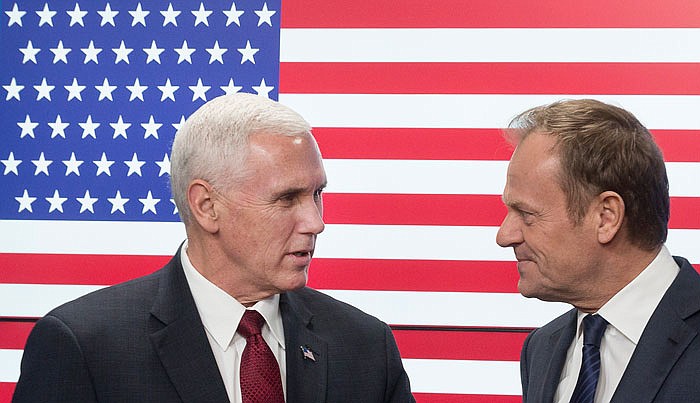 United States Vice President Mike Pence, left, and EU Council President Donald Tusk pose for photographers as Pence arrives at the European Council building in Brussels, Belgium, on Monday. In the background is a U.S. flag with 51 stars.