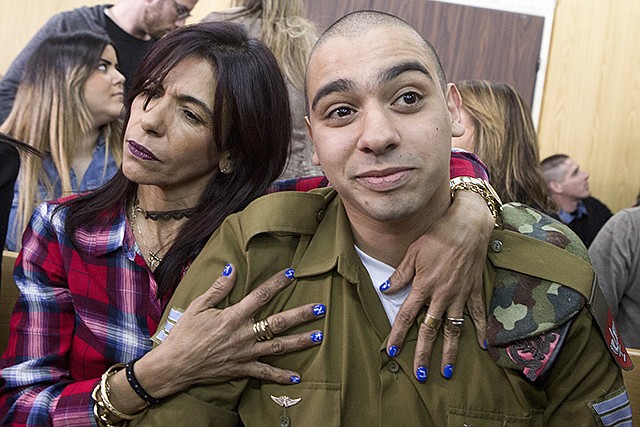 Israeli soldier Elor Azaria is embraced by his mother at the start of his sentencing hearing Tuesday in Tel Aviv, Israel. The court sentenced Azaria to 18 months in prison for the fatal shooting of a wounded Palestinian assailant. Prosecutors had asked that Sgt. Elor Azaria be sentenced to three to five years in prison.