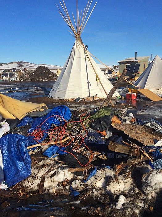 Debris is piled on the ground awaiting pickup by cleaning crews at the Dakota Access oil pipeline protest camp in North Dakota.