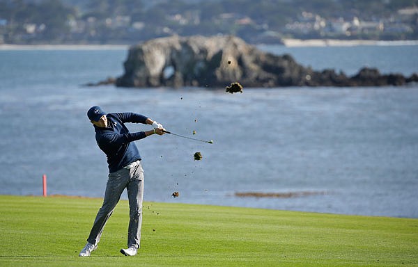 Jordan Spieth follows his approach shot from the fairway to the 18th green of the Pebble Beach Golf Links during the final round of the AT&T Pebble Beach National Pro-Am earlier this month in Pebble Beach, Calif. Spieth, who won the tournament by four strokes, is the current favorite for this year's Masters.