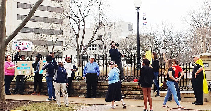 Protestors from St. Louis area community colleges protest in front of the Governor's Mansion on Monday. The group of professors and students were voicing their displeasure over Gov. Eric Greitens' proposed cuts to higher education funding.