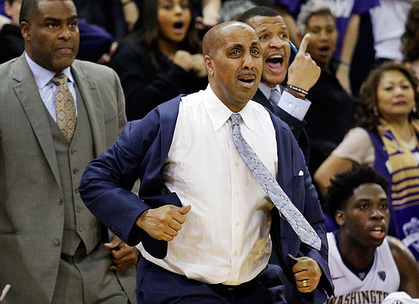 Washington head coach Lorenzo Romar tugs on his jacket as a call goes in favor of Arizona late in the second half of last Saturday's game in Seattle. Romar's future is in question as the Huskies are likely headed toward their worst season of Romar's 15-year tenure and a sixth straight season of missing the NCAA tournament. 