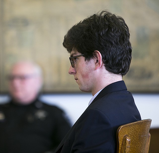 Owen Labrie listens to testimony Tuesday at the Merrimack County Superior Court during the first day of a hearing on whether he deserves a new trial in Concord, New Hampshire. Labrie claims his trial lawyers failed to challenge the felony charge. He was acquitted in 2015 of raping a 15-year-old classmate as part of a game of sexual conquest at St. Paul's School but was convicted of a felony computer charge requiring him to register as a sex offender.