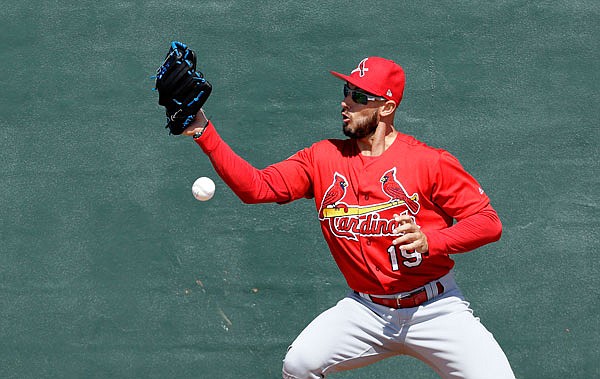 Jordan Schafer of the Cardinals tries to catch a ball as part of a drill during a spring training workout last week in Jupiter, Fla.