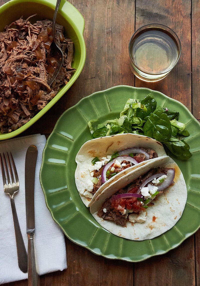 This December 2016 photo shows barbacoa beef tacos in New York. This dish is from a recipe by Katie Workman. 