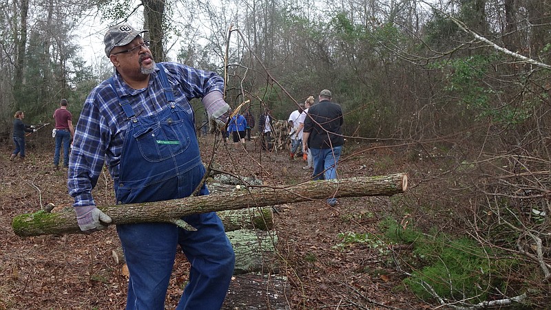 Mason Darrell Barrett of Birmingham, Ala., joins other volunteers Saturday to help to clear land in what is thought to be the Old Macedonia Cemetery in Linden, Texas.