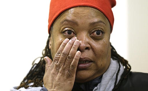Tracy Adams, a plaintiff in a federal lawsuit filed Wednesday, Feb. 22, 2017, by the American Civil Liberties Union of Wisconsin, on behalf of her 17-year-old minor son, wipes a tear away during a news conference in Milwaukee. The lawsuit was filed on behalf of six black and Latino plaintiffs who say they've been stopped once or multiple times since 2010 without a citation or clear explanation. The lawsuit alleges the Milwaukee Police Department's stop-and-frisk program is citywide but is concentrated in areas largely populated by minorities. (Mike De Sisti/Milwaukee Journal Sentinel via AP)