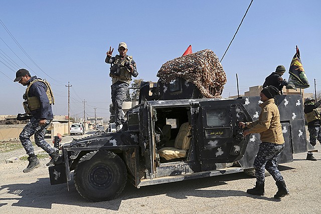 Iraqi federal police deploy Wednesday after regaining control of the town of Abu Saif, west of Mosul, Iraq. Iraq's government-sanctioned paramilitary forces, made up mainly of Shiite militiamen, have launched a new push to capture villages west of the city of Mosul from Islamic State militants.