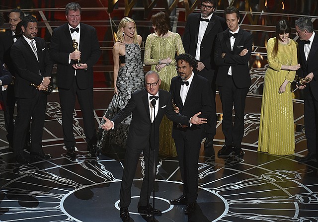 Actor Michael Keaton, foreground center, and director Alejandro G. Inarritu, foreground right, are shown in February 2015 with the cast and crew of "Birdman or (The Unexpected Virtue of Ignorance)"as they  accept the award for the best picture at the Oscars in Los Angeles.