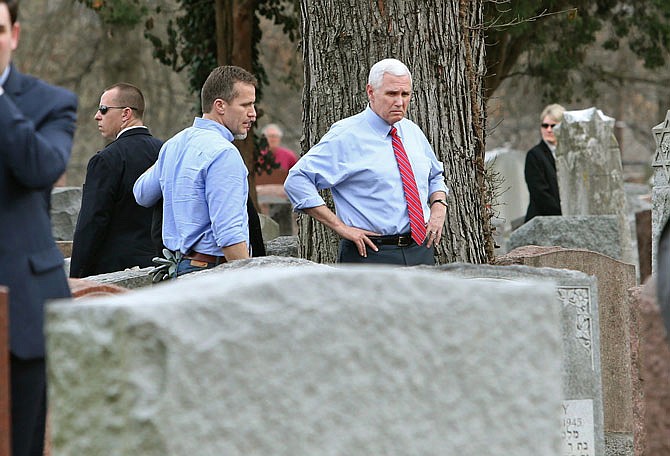 Gov. Eric Greitens and Vice President Mike Pence view some of the damage done at the Chesed Shel Emeth Cemetery in University City  on Wednesday. More than 150 headstones had been overturned by vandals. 