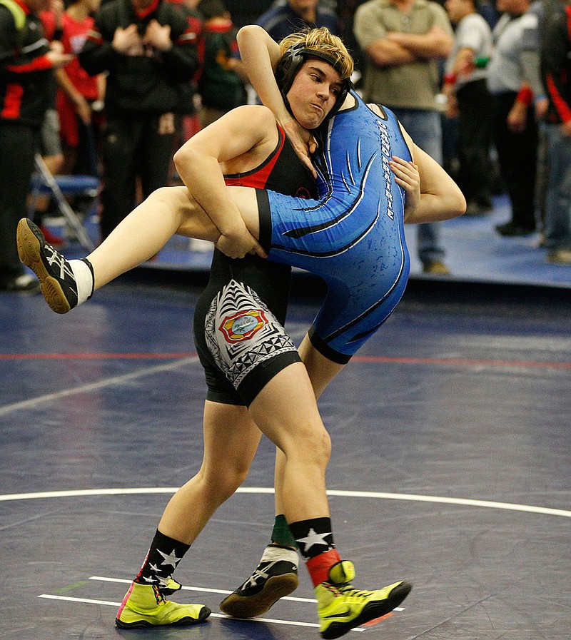 In this Feb. 18, 2017 photo, Euless Trinity's Mack Beggs, left, wrestles Grand Prairie's Kailyn Clay during the finals of the UIL Region 2-6A wrestling tournament at Allen High School in Allen, Texas.  Beggs, who is transgender, is transitioning from female to male, won the girls regional championship after a female opponent forfeited the match.