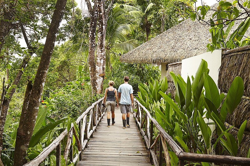 This undated photo shows visitors walking down a path at the Lapa Rios Lodge in Costa Rica. Owner Hans Pfister says business at the lodge was hurt last year by concerns over the Zika virus, which is spread by mosquitoes, but this year Zika has faded from the headlines and Pfister says his guests are back. 